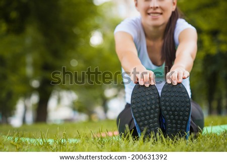 young woman doing exercises in the park