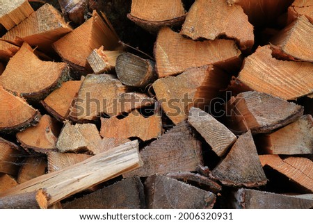 Close up of firewood or log of wood. Piled in a row against  a wall. Great storage. Safety for the cold Scandinavian winter. Logging industry. Stockholm, Sweden, Europe.