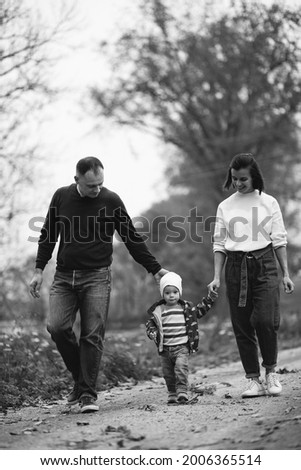 Young family with little son having fun in forest