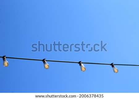 The view on the light bulbs on the blue sky background