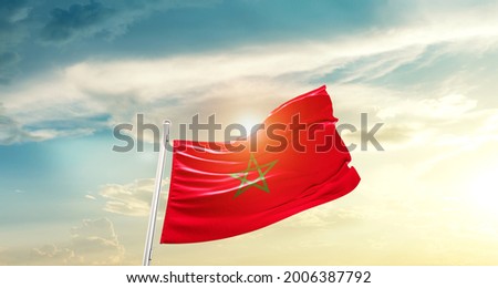Morocco national flag waving in beautiful clouds. Royalty-Free Stock Photo #2006387792