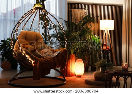 Indoor terrace interior with comfortable hanging chair and houseplants Royalty-Free Stock Photo #2006388704