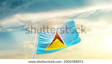 Saint Lucia national flag waving in beautiful clouds.