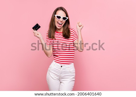 Photo of young excited girl happy positive smile rejoice hold credit card salary money isolated over pastel color background