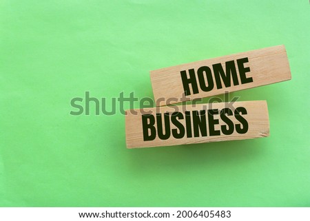 Home business symbol. Wooden blocks form the words 'home business' on beautiful green background. Home business concept. Copy space.