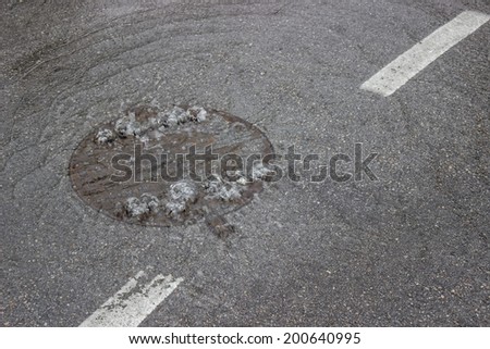 Water bubbling up through manhole cover and sewer, drain is clogged 