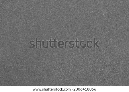 Gray abrasive paper close-up. Grainy texture.