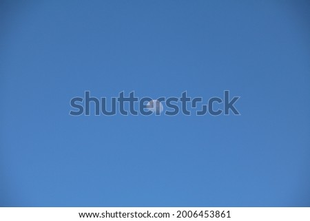 Picture of the moon in a clear blue sky