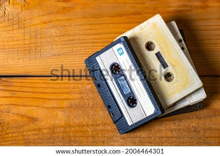 Old Audio Cassettes on a Wooden Planks Background closeup