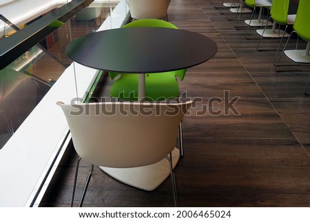 Tables and colored chairs in a modern cafe
