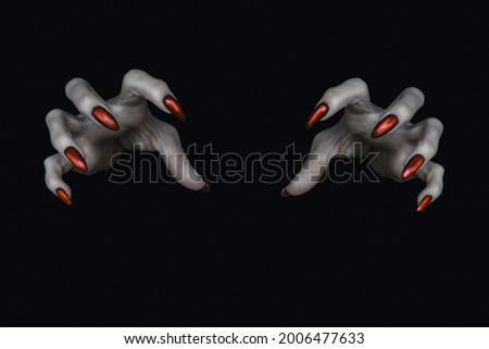Scary deathly pale knobby fingers with sharp red nails in the dark. Witch hands put a spell, low key, selected focus. Royalty-Free Stock Photo #2006477633