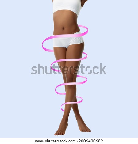 Perfect female body with the arrows spiral on her legs isolated on blue. Lifting, beauty, bodycare, healthy nutrition, sport, fitness and water balance concept. Caucasian young and slim woman as model