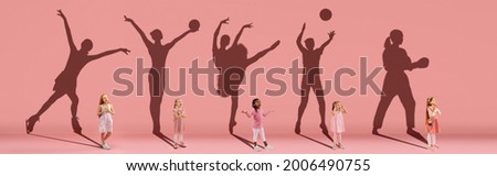 Collage. Dreams about big and famous future. Conceptual image with little girls and shadows of fit professional sportsmen on light pink, coral background. Dreams, imagination, education concept. Royalty-Free Stock Photo #2006490755