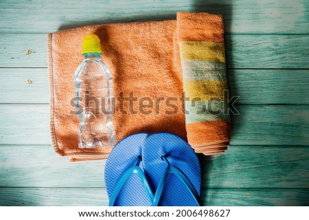 summer concept for relaxation-towels, flip-flops and a bottle of water