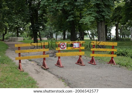 protective barrier, repair work on the street, barrier for pedestrians, signs prohibiting pedestrians from walking
