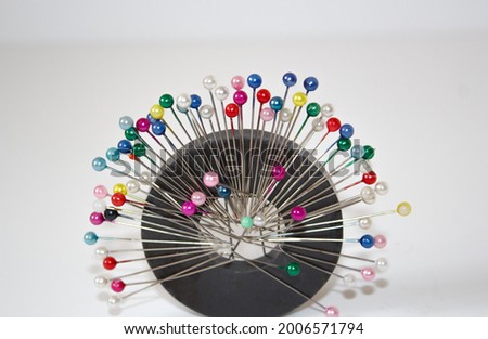 colorful pins on ring magnet white background, magnetic pin needle cushion, tailor, sewing, fashion, design materials equipments, tools, cloth fastening fabric, glass headed pin