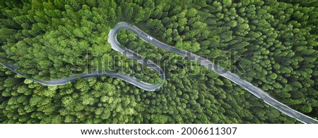 Aerial view of a road in the middle of the forest Royalty-Free Stock Photo #2006611307