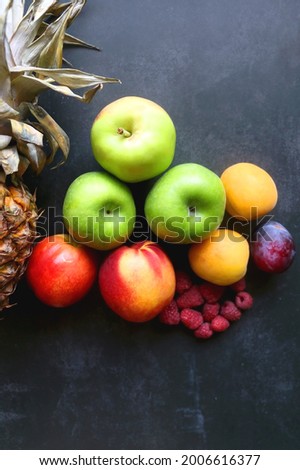 Various colorful fruit on dark background. Flat lay.