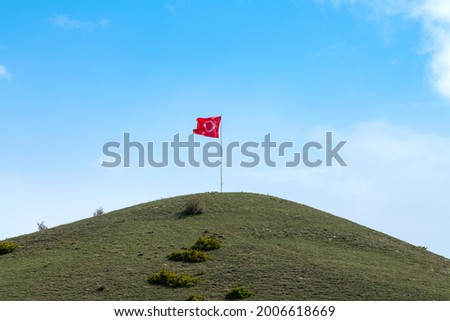Turkish flag waving on the hill above