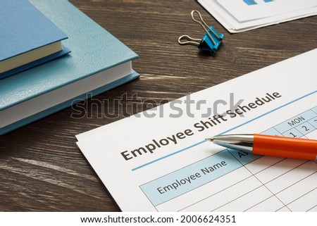 Employee shift schedule for work and pen. Royalty-Free Stock Photo #2006624351