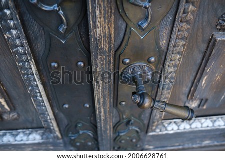 Old metal door handle on the old door.