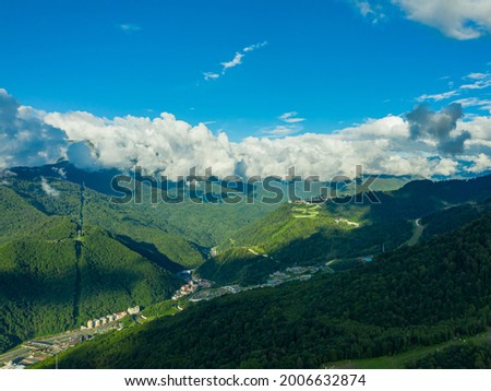 Mountain village. Aerial photography. Cloudy sky.