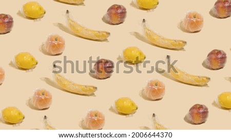 A creative idea of pattern made of 
fruits in plastic wrap. Minimal fruit concept.