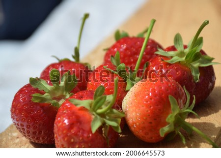 Fresh Strawberry on a Wooden Surface. Stock Photo