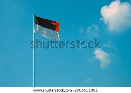 Commemoration of the independence day of the Republic of Indonesia, red and white flag under a clear sky