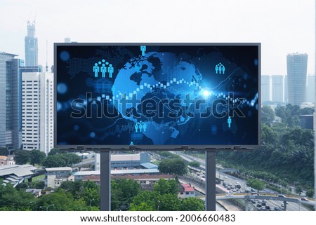 World planet Earth map hologram and social media icons on billboard over panorama city view of Kuala Lumpur, Malaysia, Asia. The concept of people networking and connections.