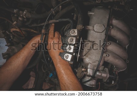 auto repair under the hood male hands dirty