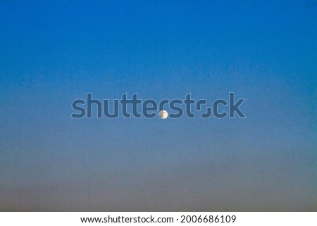 The moon over twilight evening sky background.