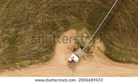 AERIAL. Circular green irrigation patches for agriculture in the desert. Dubai, UAE. Royalty-Free Stock Photo #2006689433