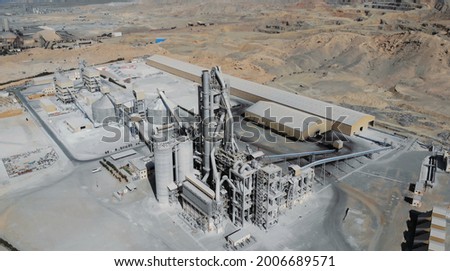 AERIAL. Top view of industry manufactory in UAE. Huge cement factory in desert. Royalty-Free Stock Photo #2006689571