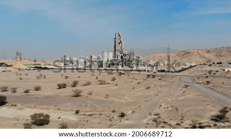 AERIAL. Top view of industry manufactory in UAE. Huge cement factory in desert. Royalty-Free Stock Photo #2006689712