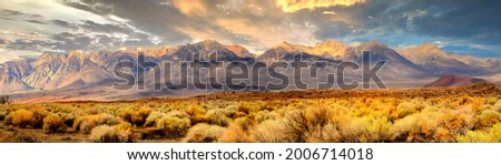 Panorama of the southern tip of the Sierra Nevada Mountains located in Central California under a clear blue sky with wispy white clouds. Royalty-Free Stock Photo #2006714018