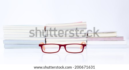 Eyeglasses with stack of book background