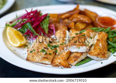 Roasted fish with vegetables on plate