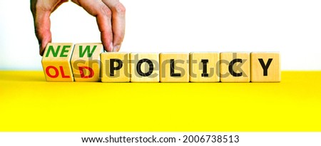 New or old policy symbol. Businessman turns wooden cubes and changes words 'old policy' to 'new policy'. Beautiful yellow table, white background. Business, old or new policy concept. Copy space. Royalty-Free Stock Photo #2006738513