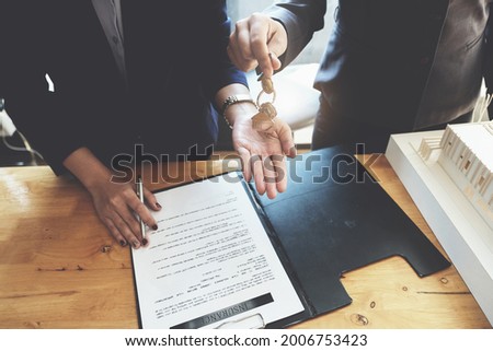 estate agent gives pen and documents agreement with customer to sign contract. Concept agreement.