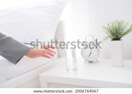 Cropped photo of charming pretty young woman hand gray nightwear waking up drinking water glass indoors house home room Royalty-Free Stock Photo #2006764067