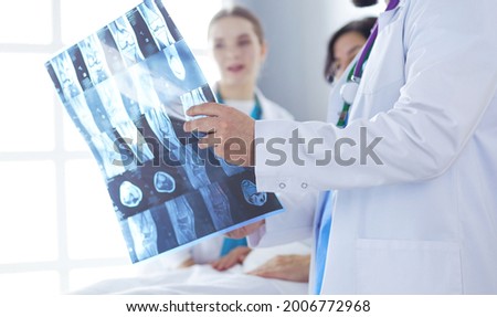 Medical team discussing diagnosis of x-ray image in office