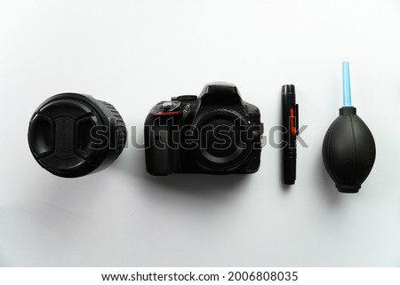 Dslr Camera with Lens and Cleaning Kit on white background