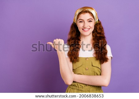 Photo of attractive young nice happy lady point finger empty space thumb sale offer isolated on purple color background