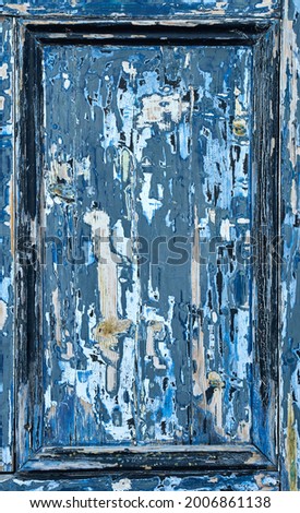 Detail of a blue door panel with very worn paint showing the wood underneath Royalty-Free Stock Photo #2006861138