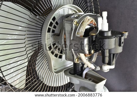 Table fan cleaning dust and maintenance by fill oil in motor. Air pure from table fan. Close up.