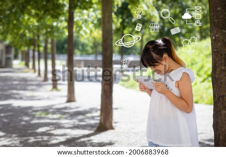 Little asian student girl watching tablet digital screen with the graph Screen Icon of a media screen Digital learning in the playground , E-learning Education Internet Technology.