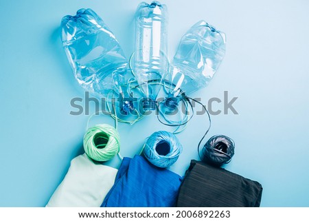 Polyester fiber synthetic fabrics eco-friendly textile recycled recyclable plastic bottles. Reuse recycling used bottles Royalty-Free Stock Photo #2006892263