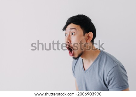 Shocked and surprised face of Asian man in isolated on white background. Royalty-Free Stock Photo #2006903990