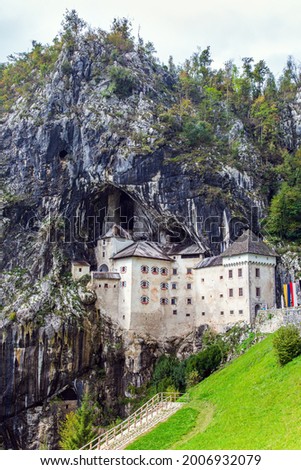 Old medieval castle in the park. Magical places in Slovenia. Postojna Cave. Limestone plateau. The famous and most visited place in the country by tourists.  Royalty-Free Stock Photo #2006932079
